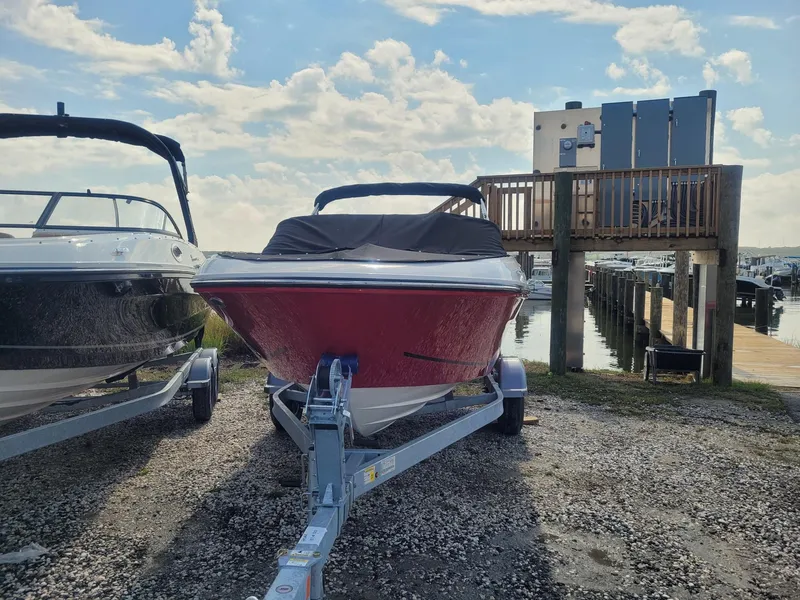 Slide: The Image of 2025 Bayliner VR4 Bowrider OB on trailer at marina, sunny day. - 3