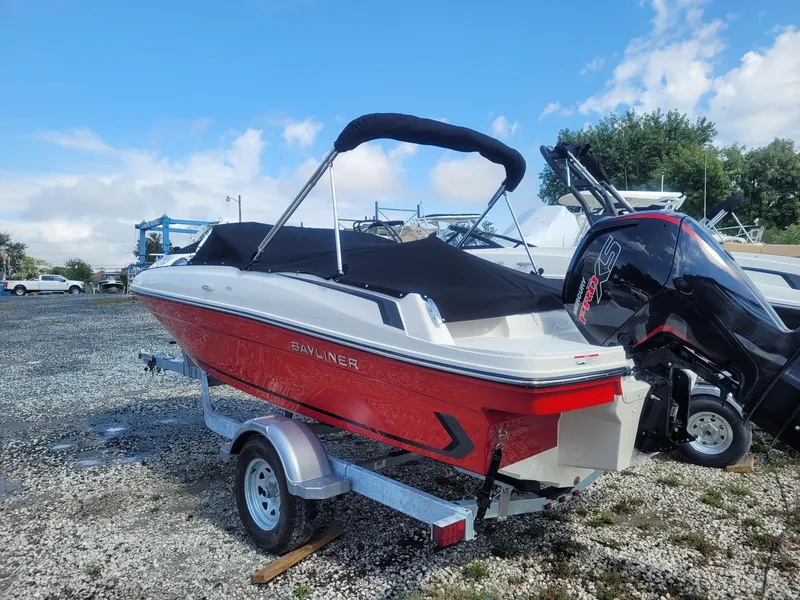 Slide: The Image of 2025 Bayliner VR4 Bowrider OB in red, parked on a trailer outdoors. - 4