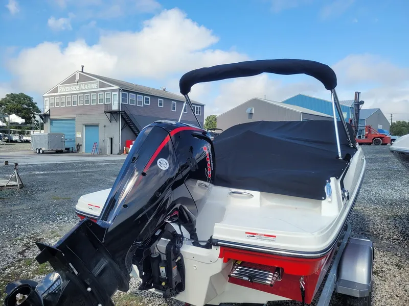 Slide: The Image of 2025 Bayliner VR4 Bowrider OB with outboard motor at a marina. - 5