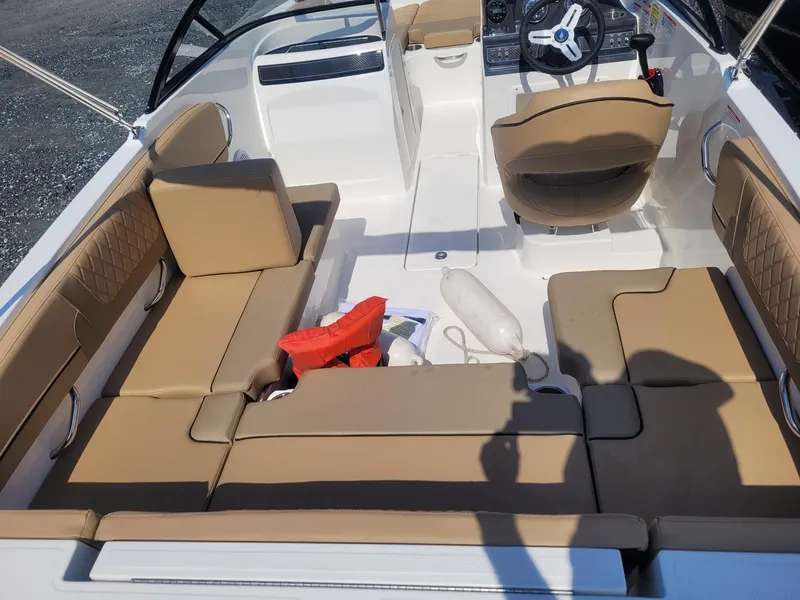 Slide: The Image of 2025 Bayliner VR4 Bowrider OB interior with tan seating and boating accessories. - 6