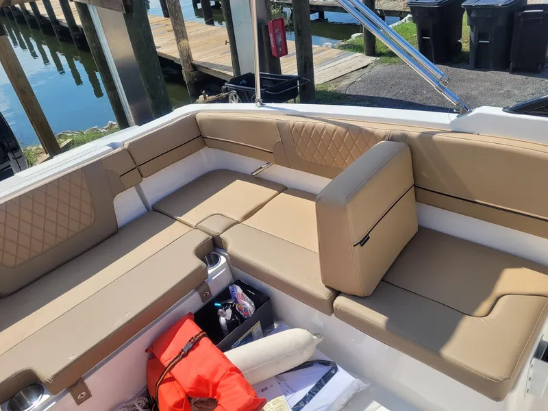 Slide: The Image of 2025 Bayliner VR4 Bowrider OB interior with tan seating and storage compartments. - 8
