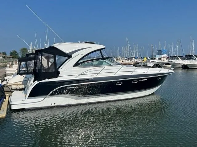 Slide: The Image of 2011 Formula 34 PC yacht docked in marina, clear blue sky background. - 10