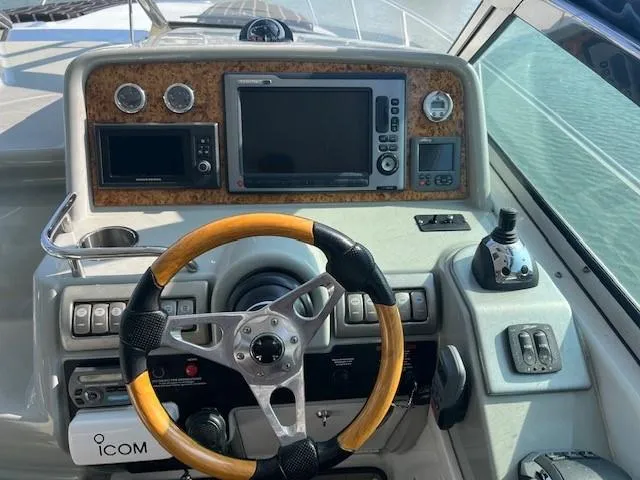 Slide: The Image of 2011 Formula 34 PC yacht dashboard with steering wheel and navigation controls. - 13