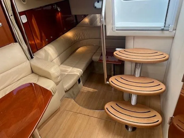 Slide: The Image of 2011 Formula 34 PC yacht interior with beige seating and wooden steps. - 14