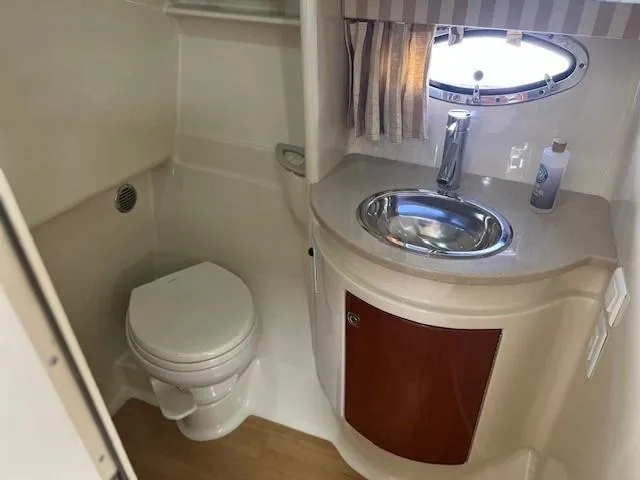 Slide: The Image of 2011 Formula 34 PC yacht bathroom with sink, toilet, and porthole window. - 15