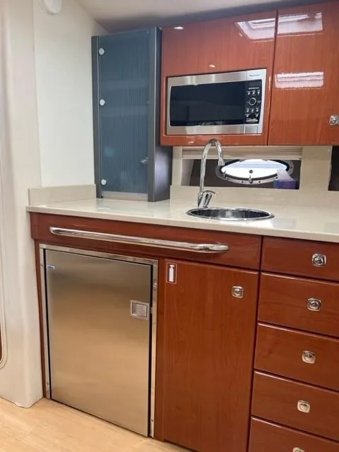 Slide: The Image of 2011 Formula 34 PC yacht kitchen with wood cabinets, stainless steel appliances, and modern fixtures. - 18