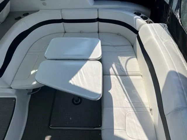 Slide: The Image of 2011 Formula 34 PC boat interior with white leather seating and adjustable table. - 27