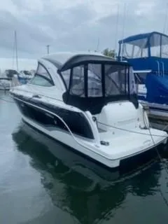 Slide: The Image of 2011 Formula 34 PC yacht docked at marina, featuring sleek design and black canopy. - 3