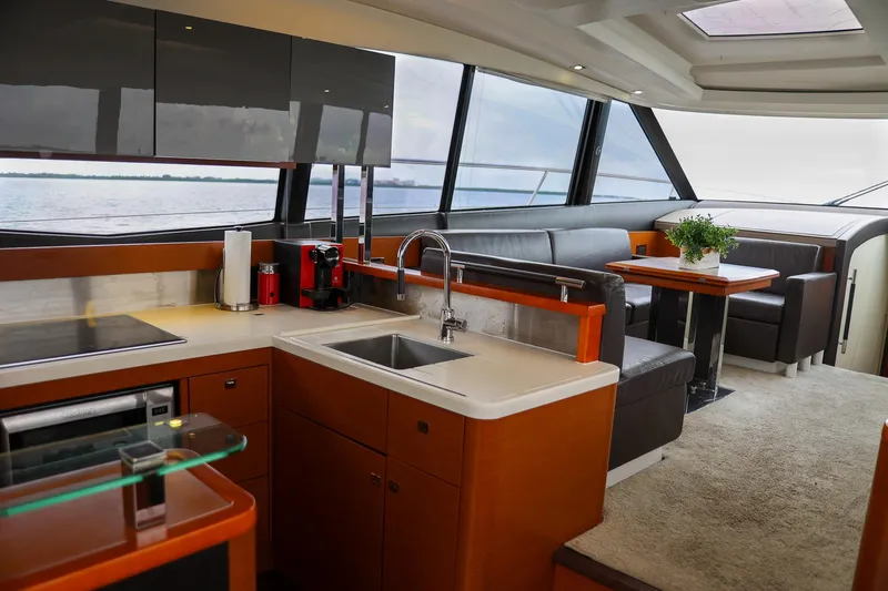 Slide: The Image of Luxurious interior of a 2015 Prestige 520 yacht with modern kitchen and seating area. - 11