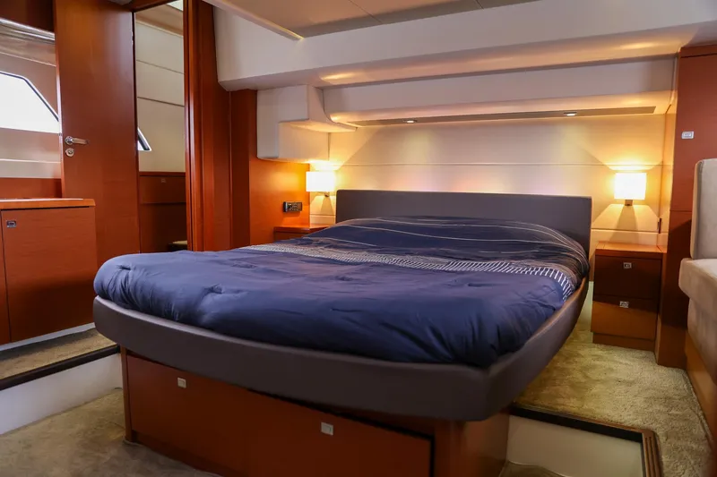 Slide: The Image of Luxurious bedroom interior of 2015 Prestige 520 yacht with cozy lighting and modern design. - 17