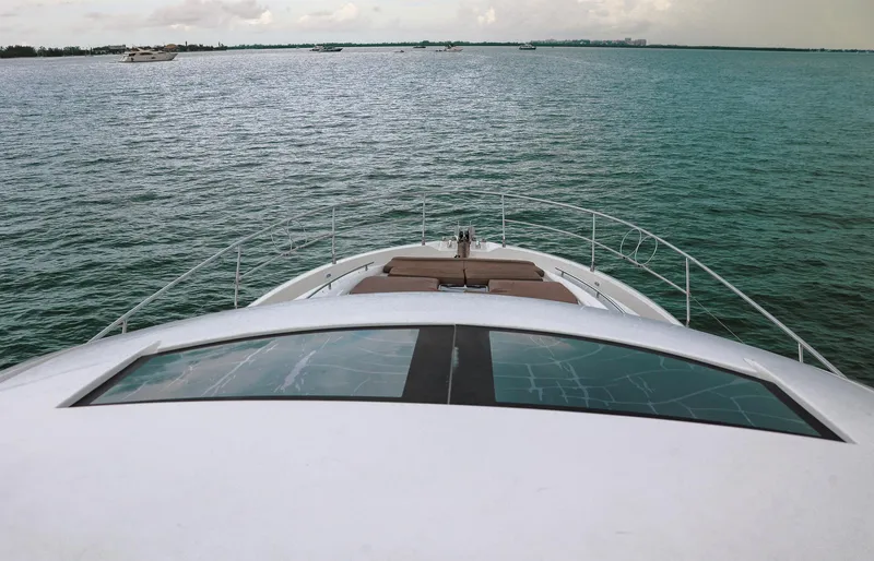 Slide: The Image of Prestige 520 yacht cruising on open water, 2015 model, with clear sky and calm sea. - 19