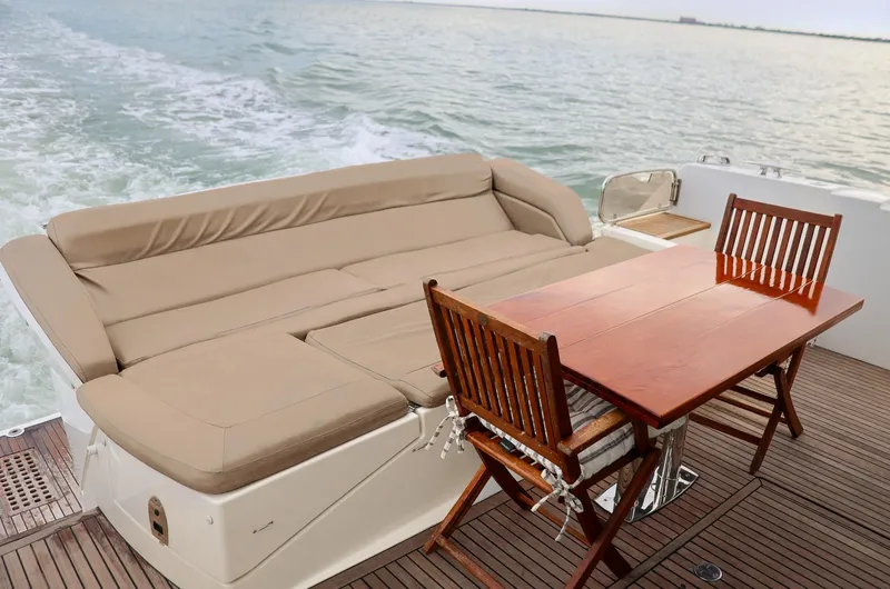 Slide: The Image of Luxurious 2015 Prestige 520 yacht deck with seating and dining area on open water. - 20