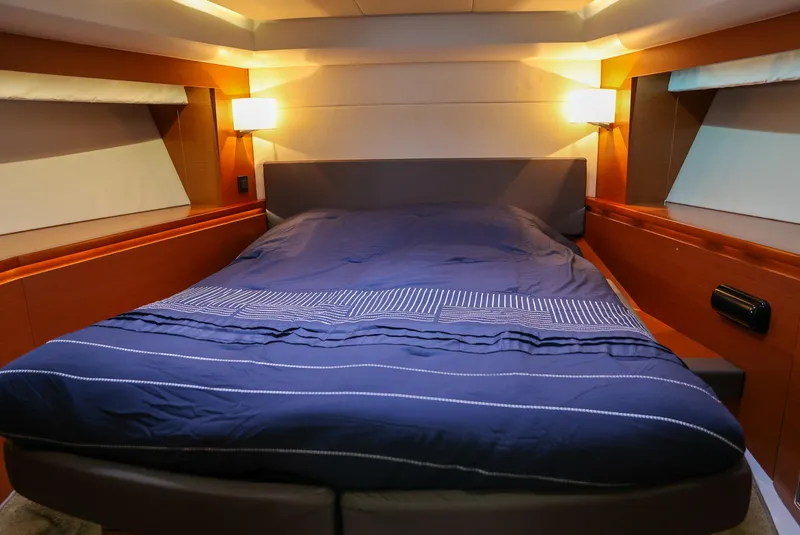 Slide: The Image of Luxurious cabin interior of 2015 Prestige 520 yacht with cozy bed and ambient lighting. - 21