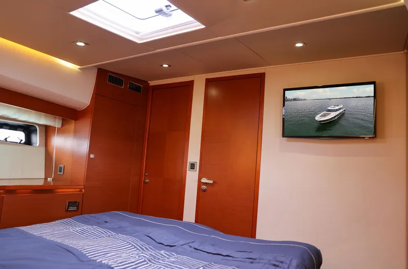 Slide: The Image of Luxurious cabin interior of 2015 Prestige 520 yacht with bed and wall-mounted TV. - 23