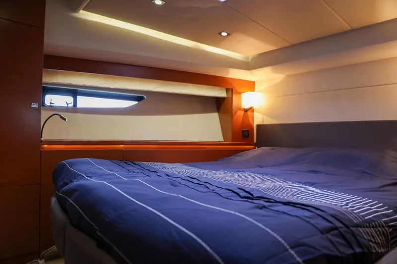 Slide: The Image of Luxurious cabin interior of 2015 Prestige 520 yacht with cozy bed and ambient lighting. - 25