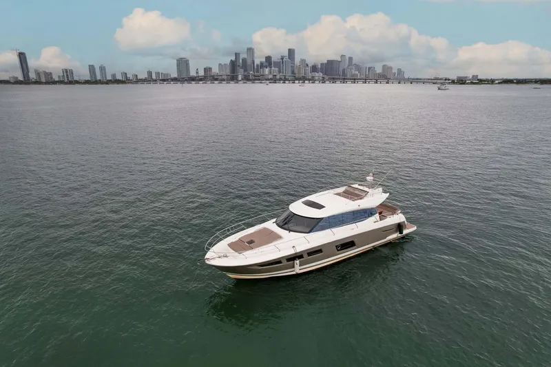 Slide: The Image of Prestige 520 yacht on water with city skyline in background, 2015 model. - 30