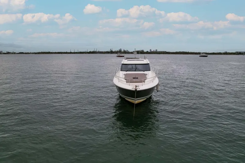 Slide: The Image of 2015 Prestige 520 yacht on calm water under a partly cloudy sky. - 32