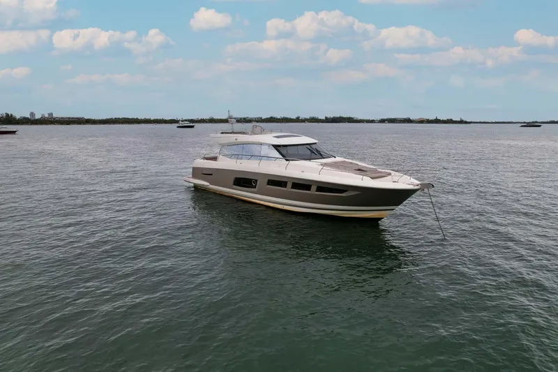 Slide: The Image of Luxury 2015 Prestige 520 yacht cruising on calm waters under a blue sky. - 33