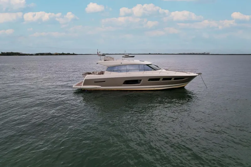 Slide: The Image of 2015 Prestige 520 yacht on calm water under a partly cloudy sky. - 34