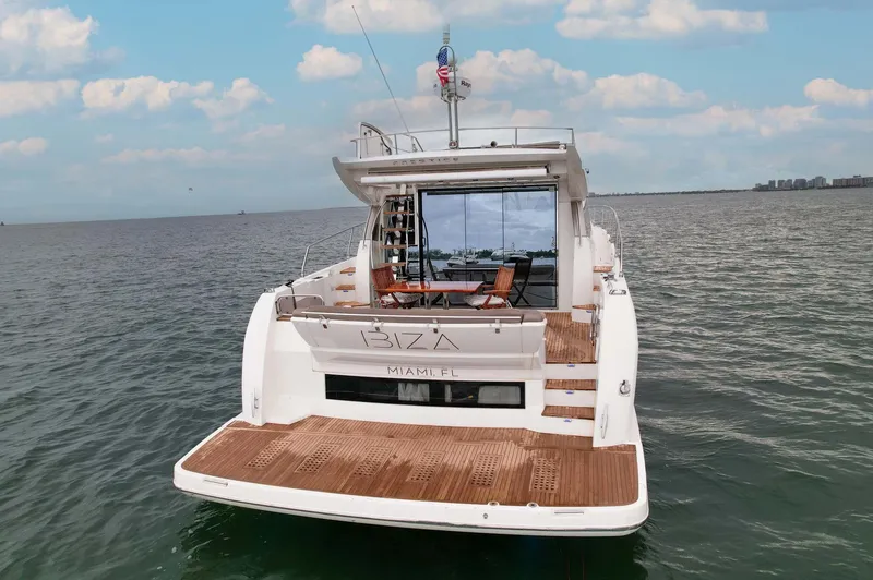 Slide: The Image of Luxury 2015 Prestige 520 yacht on open water, featuring spacious deck and elegant design. - 35