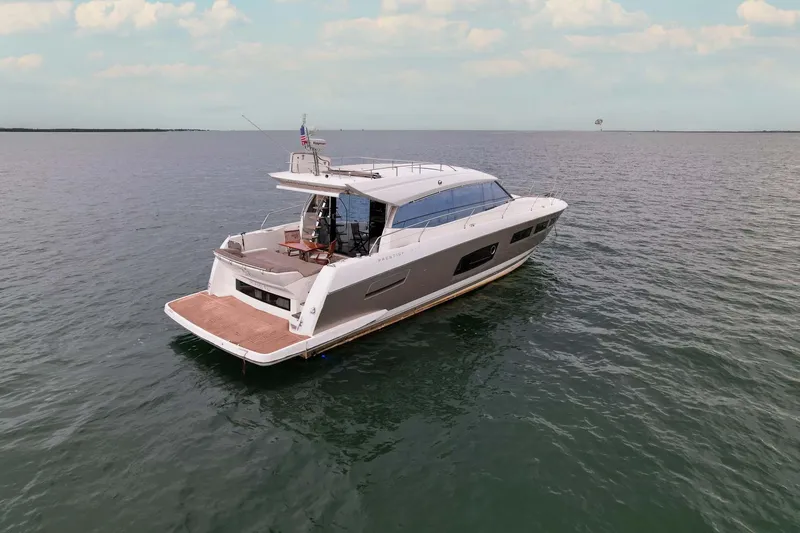 Slide: The Image of Luxury 2015 Prestige 520 yacht cruising on open water under a clear sky. - 36