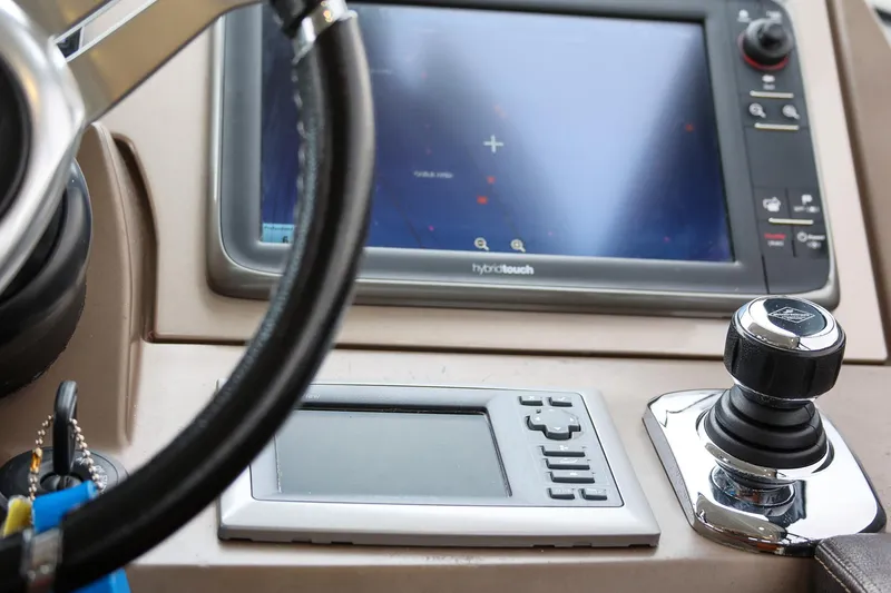 Slide: The Image of Control panel of a 2015 Prestige 520 yacht with navigation screen and joystick. - 4