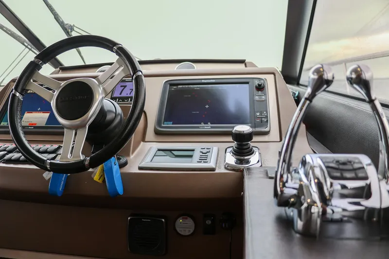 Slide: The Image of Cockpit of 2015 Prestige 520 yacht with steering wheel and navigation controls. - 5