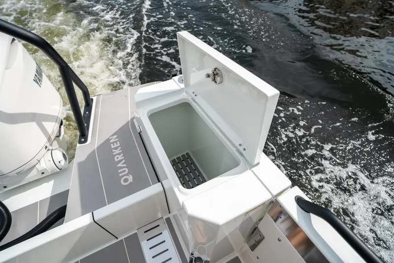 Slide: The Image of 2025 Quarken 35 Sport Tourer boat with open storage compartment on deck. - 17