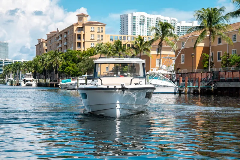 Slide: The Image of 2025 Quarken 35 Sport Tourer cruising in a scenic urban waterway. - 3