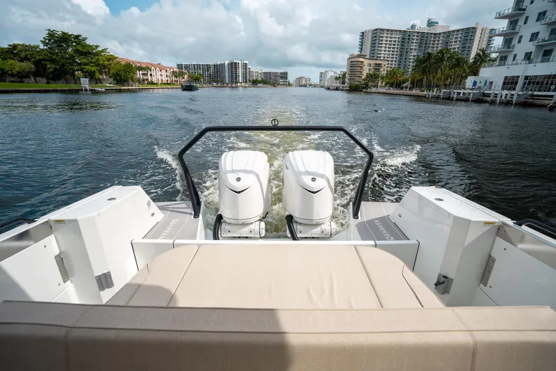 Slide: The Image of 2025 Quarken 35 Sport Tourer cruising on a scenic waterway with cityscape views. - 9