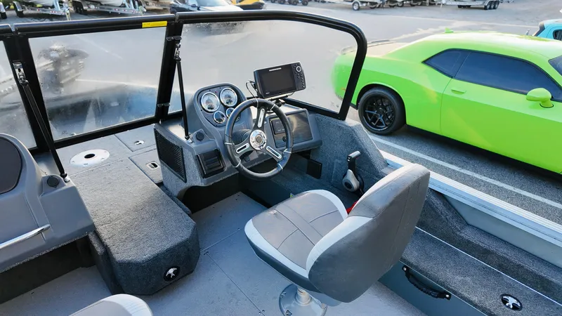 Slide: The Image of 2025 Starcraft Storm 166 DC Pro boat interior with steering console and seating. - 10
