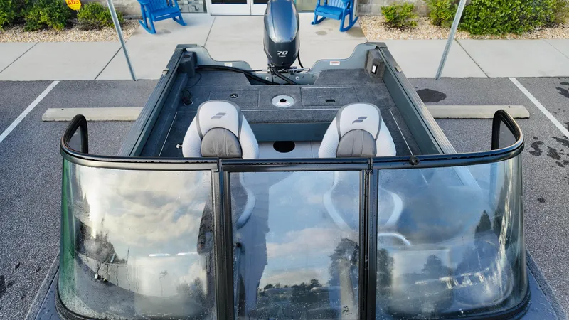 Slide: The Image of 2025 Starcraft Storm 166 DC Pro boat with dual seats and windshield in a parking lot. - 11