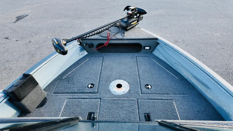 Slide: The Image of 2025 Starcraft Storm 166 DC Pro boat deck with trolling motor, gray carpet, and storage compartments. - 6
