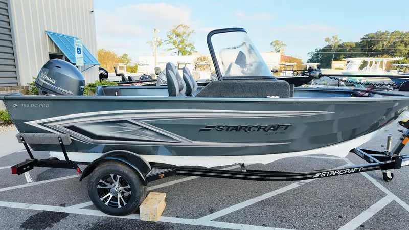 Slide: The Image of 2025 Starcraft Storm 166 DC Pro boat on trailer, parked outdoors. - 7