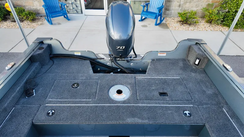 Slide: The Image of Starcraft Storm 166 DC Pro 2025 boat interior with motor, gray deck, and seating area. - 8