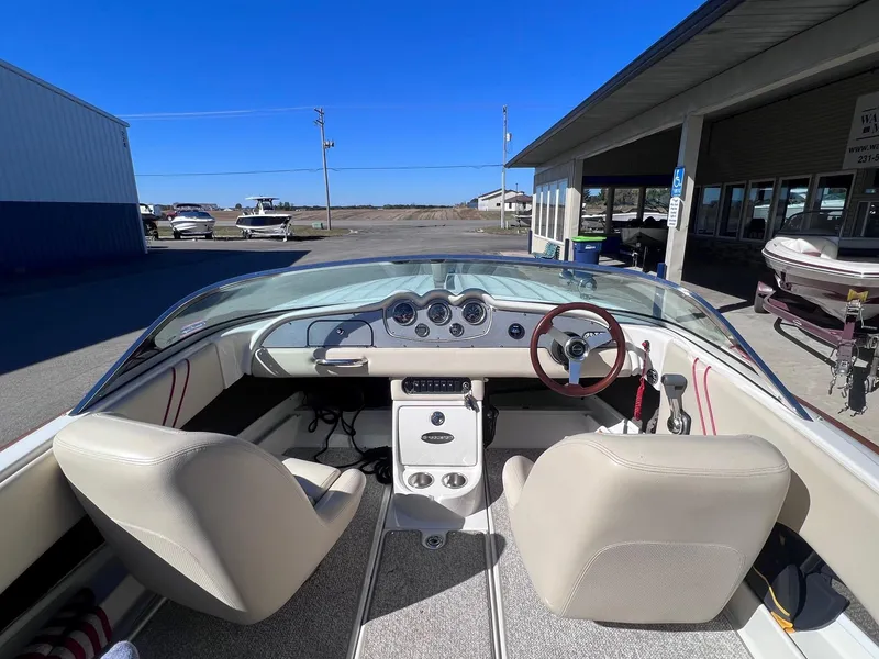 Slide: The Image of 2005 Chris-Craft Speedster boat interior with beige seats and classic dashboard. - 13