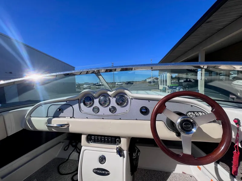 Slide: The Image of 2005 Chris-Craft Speedster dashboard with wooden steering wheel and classic gauges. - 14