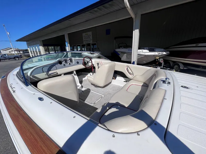 Slide: The Image of 2005 Chris-Craft Speedster boat with beige interior, parked at a marina. - 16