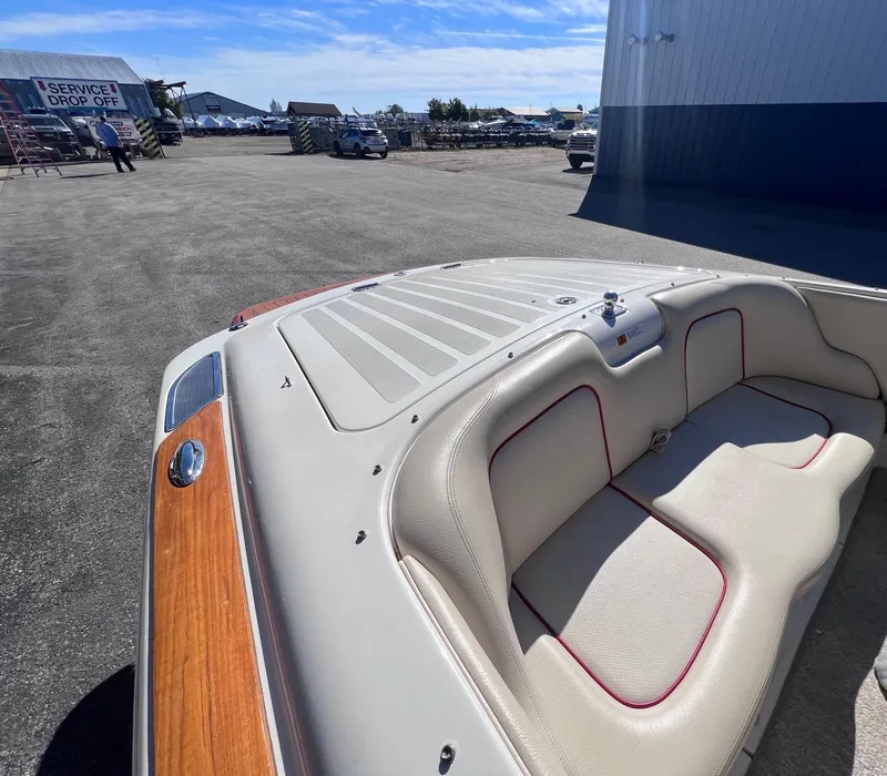 Slide: The Image of 2005 Chris-Craft Speedster boat interior with beige seating and wooden accents. - 18
