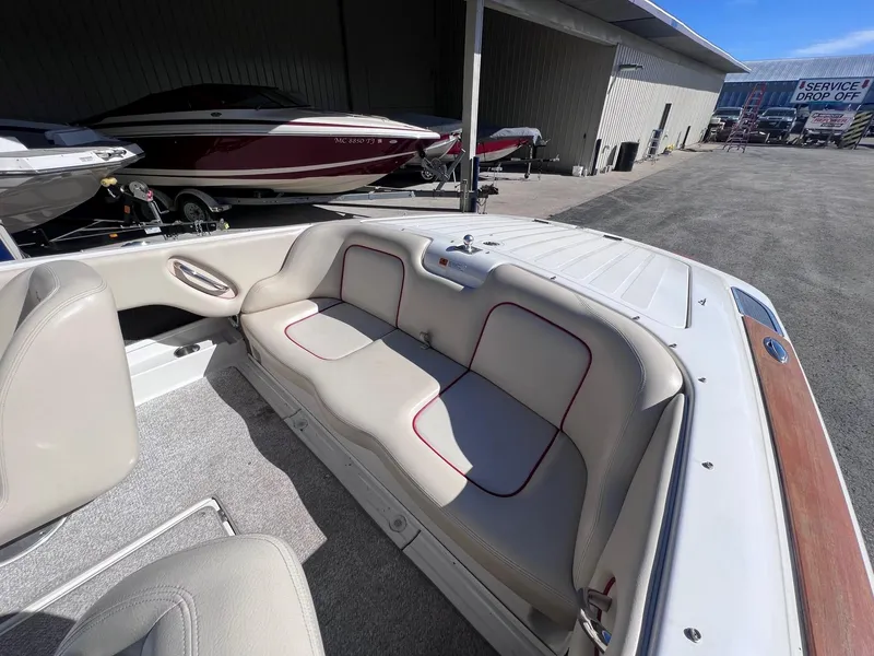 Slide: The Image of 2005 Chris-Craft Speedster boat interior with beige seating and red trim. - 19