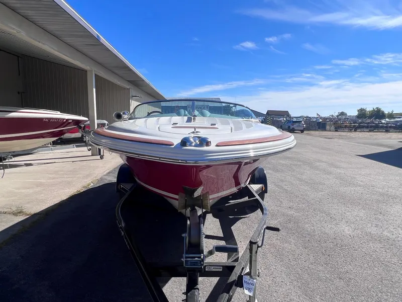 Slide: The Image of 2005 Chris-Craft Speedster boat on trailer under clear blue sky. - 2