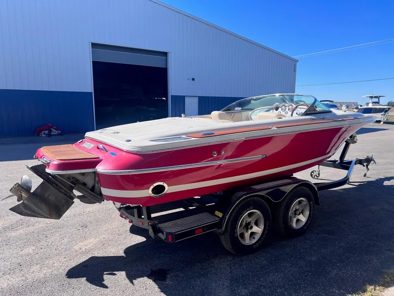 Slide: The Image of 2005 Chris-Craft Speedster boat on trailer, parked outside a warehouse. - 4