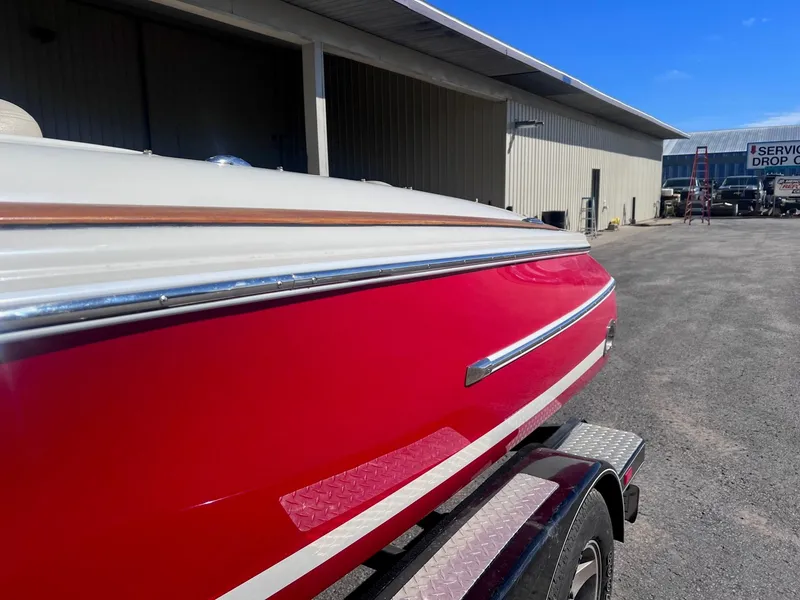 Slide: The Image of Red 2005 Chris-Craft Speedster boat on trailer near service building. - 8