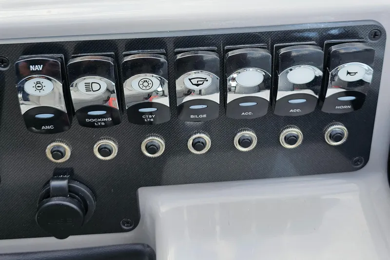 Slide: The Image of Control panel of 2025 Barletta A22UC boat with labeled switches and buttons. - 12