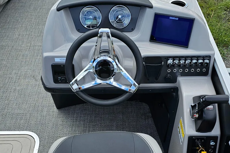 Slide: The Image of 2025 Barletta A22UC boat dashboard with steering wheel and control panel. - 14