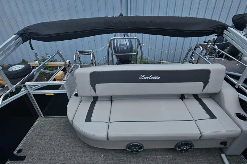 Slide: The Image of 2025 Barletta A22UC boat interior with gray seating and black canopy. - 16