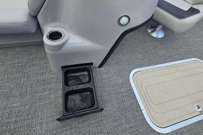 Slide: The Image of Barletta A22UC 2025 boat interior with cup holders and storage compartment. - 6