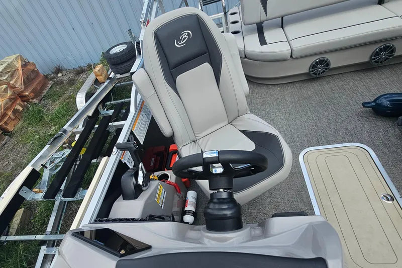 Slide: The Image of 2025 Barletta A22UC boat interior with steering wheel and seating. - 8