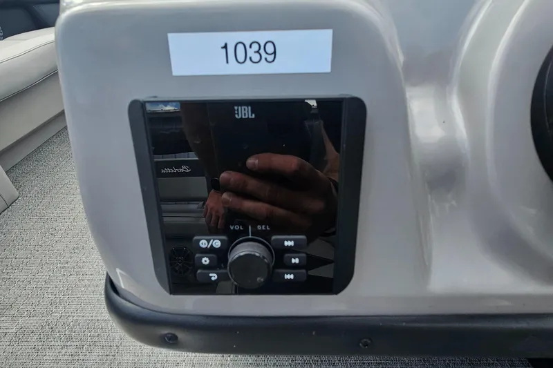 Slide: The Image of Control panel of 2025 Barletta A22UC boat with JBL audio system. - 9