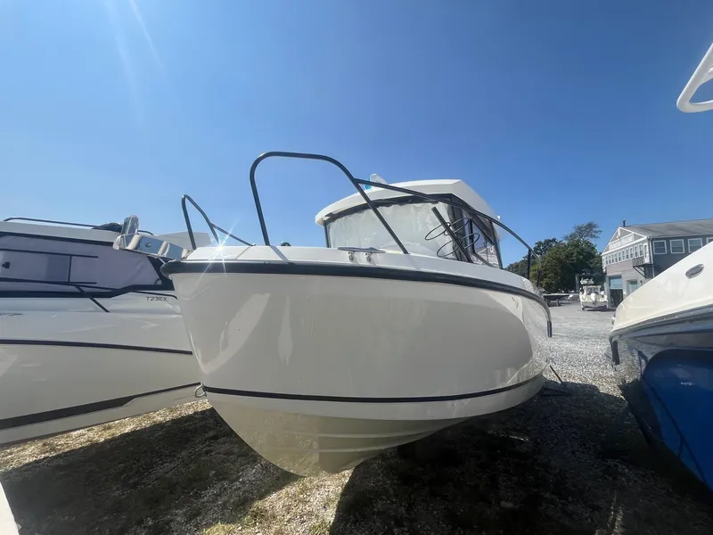 Slide: The Image of 2025 Bayliner Trophy T25 Pilothouse boat under clear blue sky. - 2